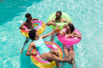 African American family enjoys a sunny pool day