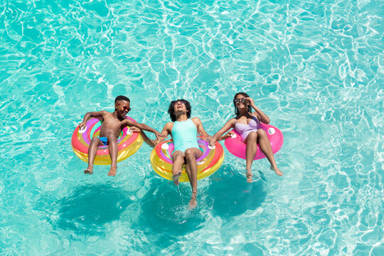 An African American family enjoys a sunny day in the pool