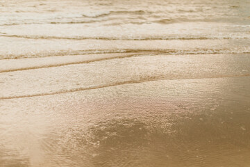 Ocean water running over sand.