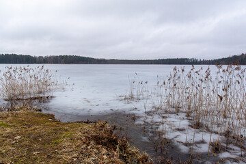 Frozen Katvari lake on a cloudy day in March in Katvari in Latvia