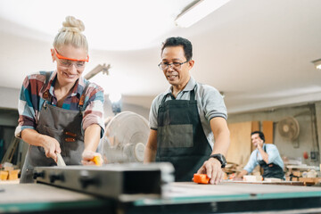 In a carpenter's shop, skilled craftsmen engage in woodwork, creating furniture with tools in a...