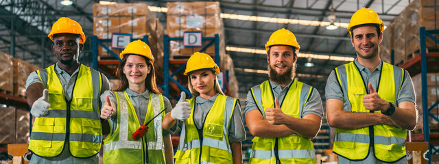 In a factory setting, a team of engineers and foremen emphasize safety and teamwork during a meeting, ensuring success in the construction industry. - 763442505