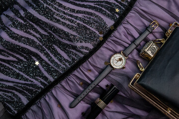 Rotating background of different fashionable women's accessories,things,watches,makeup brushes necklace,bracelet or jewelry on a pink background close-up top view