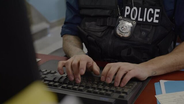 Typing police officer close up