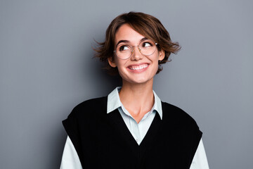 Photo of positive dreamy lady entrepreneur dressed black vest eyewear looking empty space isolated...