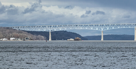 view of the Kingston-Rhinecliff Bridge from Kingston point beach (continuous under deck truss toll bridge across hudson river in new york state)