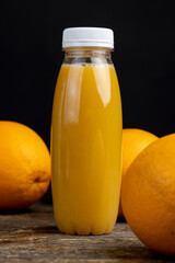 peeled juicy oranges and orange juice on the table