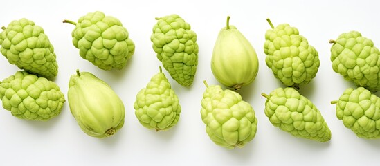 Fototapeta premium Group of green fruits on white surface