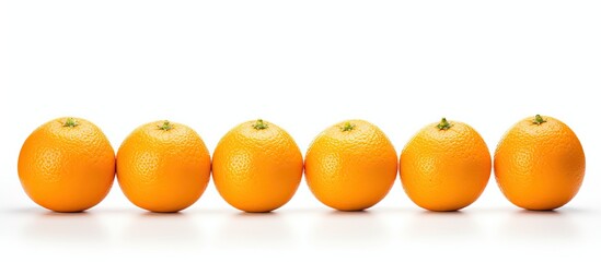 Several oranges arranged in a line on a white surface