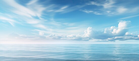 Calm ocean under blue sky with distant clouds