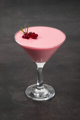 Italian dessert. Pomegranate cream jelly dessert, Panna Cotta in martini glass.  Dark background. Close-up