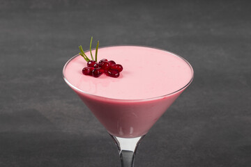 Vegan Pomegranate cream dessert, Panna Cotta in martini glass.  Dark background. Close-up