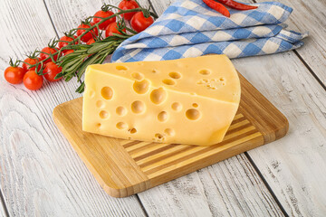 Maasdam cheese piece over board