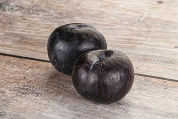 Two ripe sweet black plums