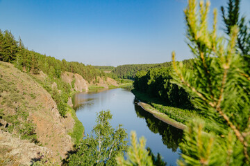 Fototapeta premium Tranquil River in Verdant Summer Woodlands