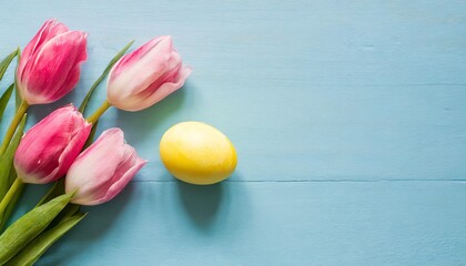 spring flowers and colorful easter egg with pastel blue background