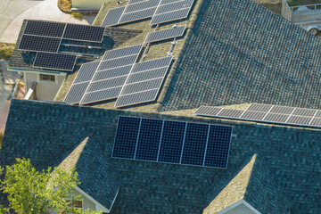 American residential house with rooftop covered with solar photovoltaic panels for producing of...