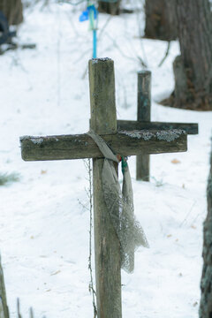 Wooden cross at abandoned cemetery in winter