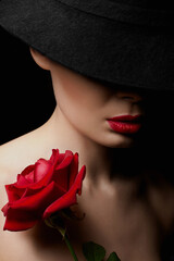 Beautiful young Woman In Hat and Flower. Pretty girl with make-up and Red Rose - 763474392