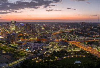 Fototapeta premium Cincinnati Ohio urban architecture in city downtown at night. Panoramic view of business district skyline with high-rise buildings at nightfall