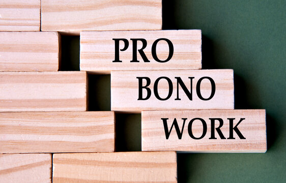 PRO BONO WORK - words on wooden blocks on dark green background