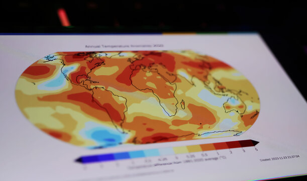 Viersen, Germany - March 9. 2024: Smartphone screen on computer keyboard with World  Meteorological Organization WMO state of global climate warming map