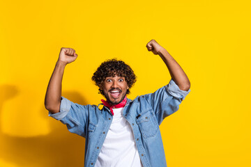 Photo portrait of attractive young man raise fists scream yes wear trendy denim clothes red scarf...