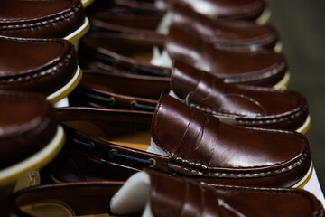 Leather shoes were lined up on the store shelves. Men elegant shoes in a man clothing boutique. Shoes trade show.