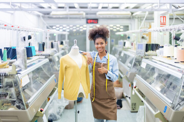 American female designer is a seamstress in the middle of a ceiling weaving factory, a company...