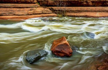 Oak Creek flows past gray and red boulders at Slide Rock State Park near Sedona Arizona - 763484536