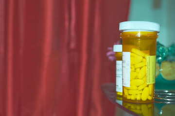 Bottle of yellow pills in closeup