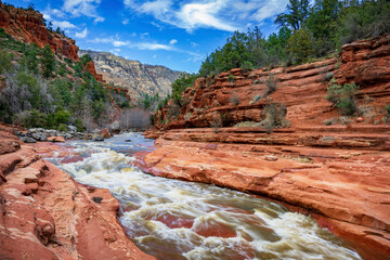 Oak Creek rushes through red sandstone at Slide Rock State Park near Sedona Arizona - 763486756