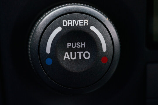 Turning on the air conditioning of a car on the climate control panel