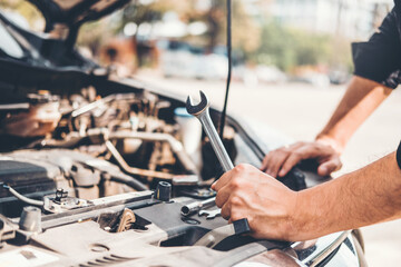 Auto mechanic working in garage Technician Hands of car mechanic working in auto repair Service and Maintenance car check