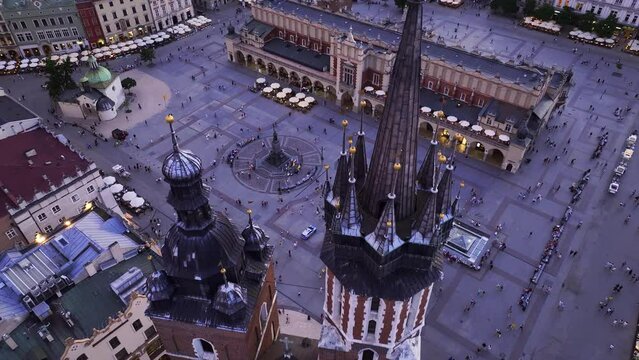 Drone Flight Over St. Mary&rsquo;s Basilica, Main Market Square, St. Adalbert&rsquo;s Church and Adam Mickiewicz Monument at Sunset, Krakow, Poland

