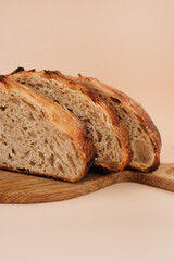 sliced bread on a wooden board and beige background