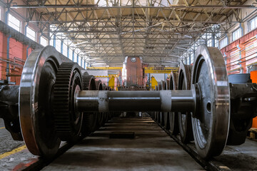 Row of steel wagon train wheels for replacement on locomotive. Repair depot. Wheels of train in service.