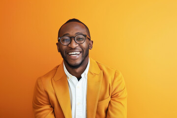 A content man in an orange jacket smiles gently against a plain orange background, exuding warmth and friendliness - obrazy, fototapety, plakaty