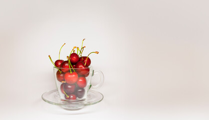 Close-up view of fresh, ripe red cherries in glass bowl - 763504794