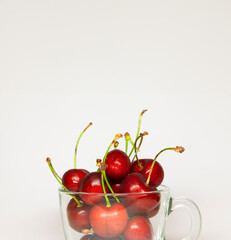 Glass bowl filled with delicious, juicy red cherries - 763504796