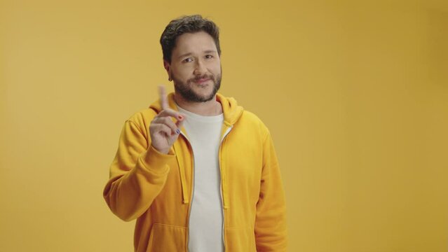 Young confident caucasian man in yellow casual clothes look camera pointing fingers himself ask say who me no thanks i do not need it isolated on yellow color background in studio

