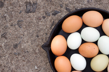 a black pan with colorful eggs on it with top view close up