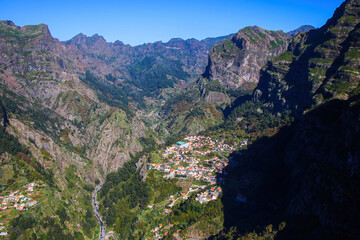 View of the village of Curral das Freiras (Corral of the Nuns) from the Eira do Serrado viewpoint in the mountainous setting of the Valley of the Nuns on Madeira island, Portugal