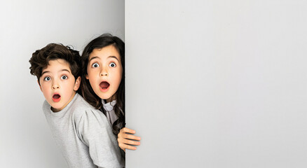 Two children looking out of the wall - obrazy, fototapety, plakaty