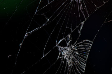 Detailed texture of broken glass, broken phone screen, on a black background.