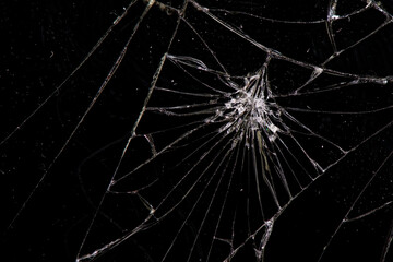 Detailed texture of broken glass, broken phone screen, on a black background.