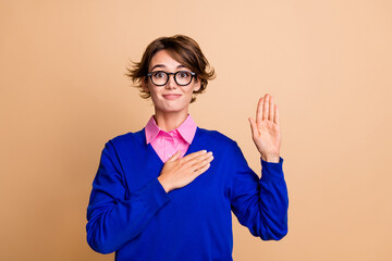 Portrait of candid friendly pretty person arm touch chest heart raise palm promise swear empty space isolated on beige color background