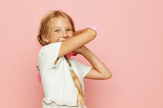 Captivating Childhood: Stylish Schoolgirl with Pink Handbag Ponders Thoughtfully in Colorful Studio