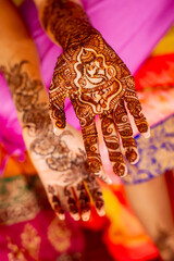 Close up detail of Ganesha henna tattoo pattern on bridal hand for mehndi ceremony