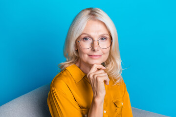 Photo of blonde pretty retired female thoughtful sit armchair dressed stylish yellow satin outfit...